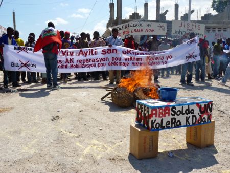 A 2009 demonstration against MINUSTAH. Banner reads  "Long Live Haiti Without Occupation. Justice And Reparations For The Victims Of Cholera." Photo by Ansel Herz, Creative Commons 2.0.