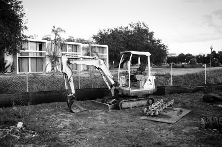 An excavator sits idle outside a derelict motel in Celebration, just outside of Orlando. In a state where Disney's Magic Kingdom exists just miles from urban slums, the collapse sheds strange subtropical light on the uneasy relationship between fantasy and reality. PHOTO: Neal Rockwell.