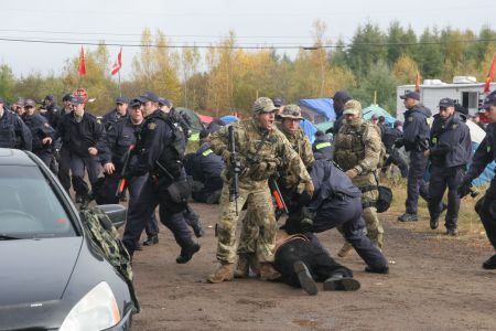 For three weeks, from late September to mid-October, activists managed to blockade key pieces of SWN's seismic testing equipment, including five "thumper" trucks. On October 17th, RCMP brutally attacked the peaceful encampment, firing less-lethal rounds, pepper spraying activists and arresting 40 people. Pictured is Mi'kmaq War Chief Seven Bernard, after being shot twice in the legs by less-lethal rounds. Photo by Mile Howe